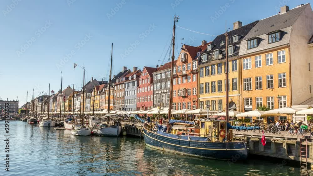 Nyhavn canal, one of the most iconic and most visited places in Copenhagen. Colorful house facades and sailing boats. Time lapse video. Nyhavn canal, one of the most iconic and most visited places in Copenhagen. Colorful house facades and sailing boats. Time lapse video.
