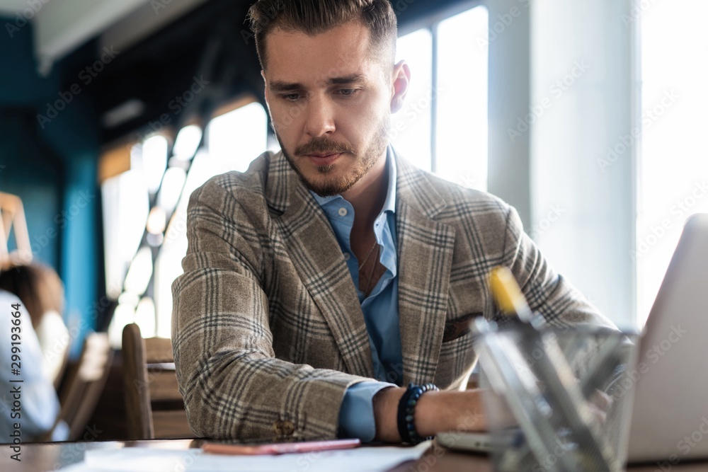 Fototapeta premium Man Working At Laptop In Contemporary Office