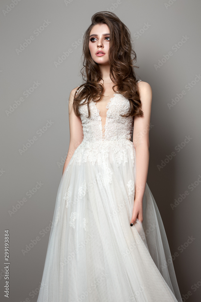 Bride photo of a beautiful model with bride makeup and hairstyle. Model dressed in white lace bride dress. Bride photo of a beautiful model with bride makeup and hairstyle. Model dressed in white lace bride dress.