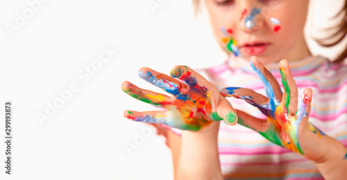 Beautiful young girl with colorful painted hands. Art, creativity and childhood concept.