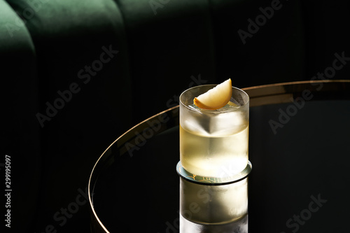 Classic cocktail glass on glass table in night club restaurant, close-up