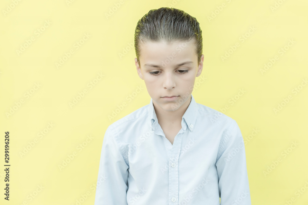 portrait of a boy with different facial expressions isolated on a yellow background portrait of a boy with different facial expressions isolated on a yellow background