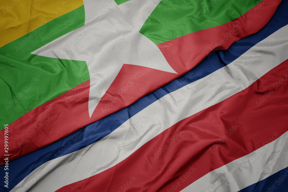 waving colorful flag of costa rica and national flag of myanmar.