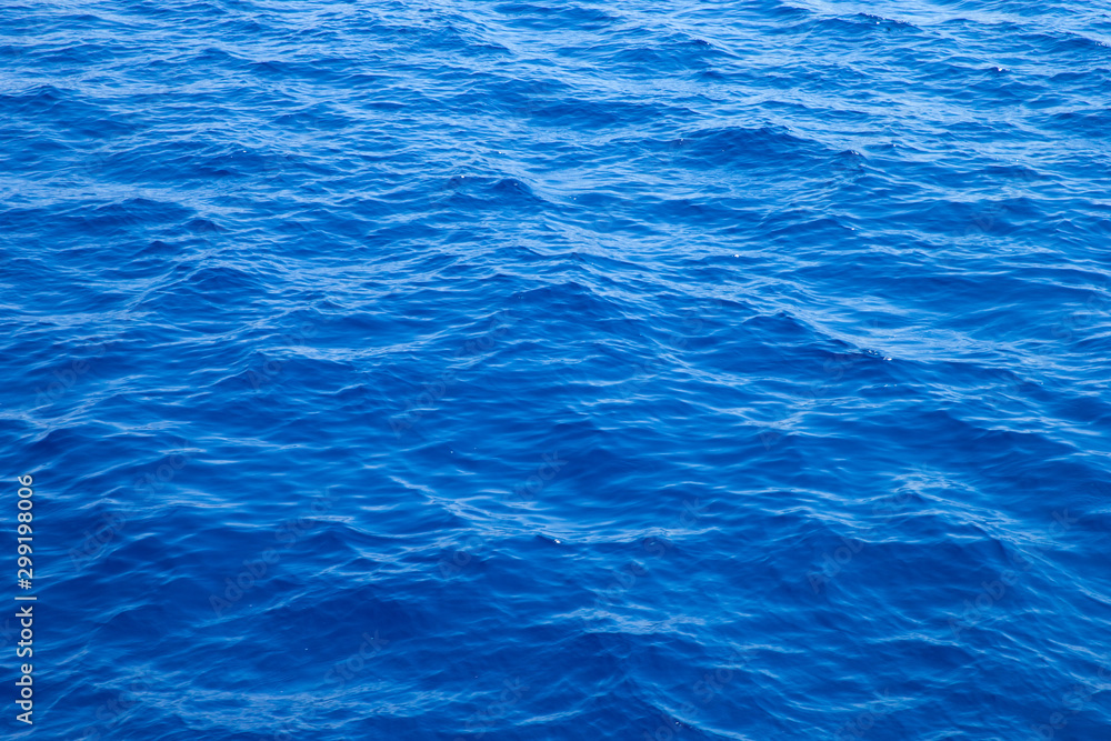 Sea background . Blue water with sun reflections Sea background . Blue water with sun reflections