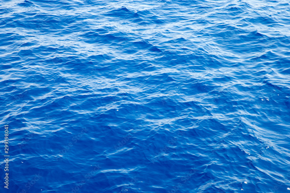 Sea background . Blue water with sun reflections Sea background . Blue water with sun reflections