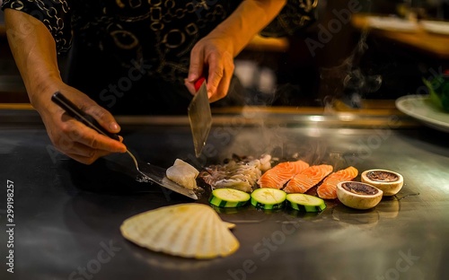teppan show in a Japanese restaurant  cooking directly in front of the client  fish  rice  meat  vegetables