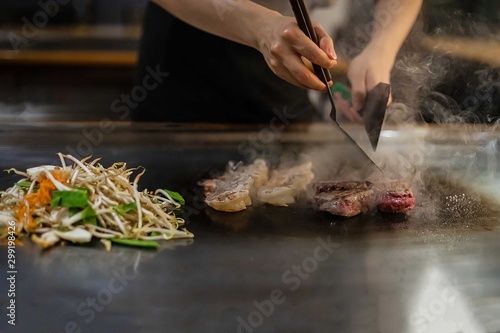 teppan show in a Japanese restaurant, cooking directly in front of the client, fish, rice, meat, vegetables photo