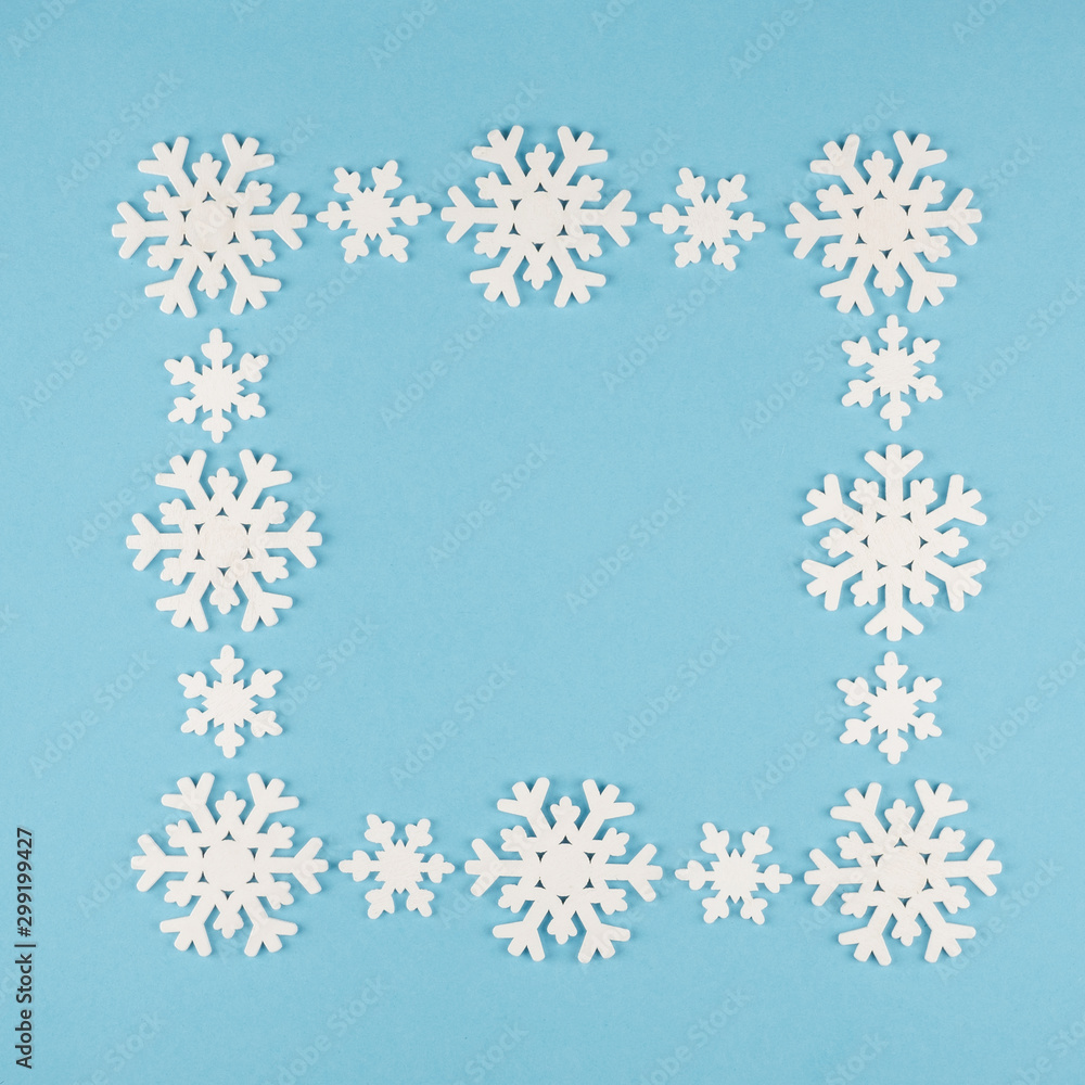 Square frame of white snowflakes and place for text on a blue background. Square frame of white snowflakes and place for text on a blue background.