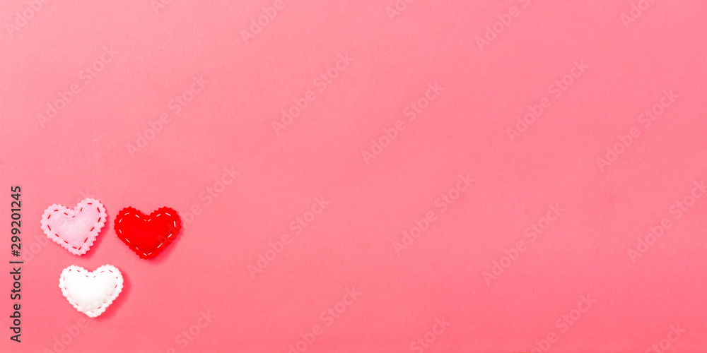 Heart cushions in Valentine's day theme on a pink paper background