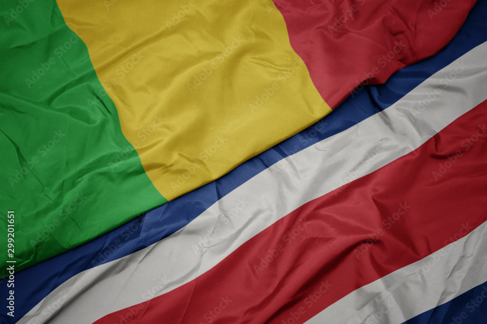 waving colorful flag of costa rica and national flag of mali.