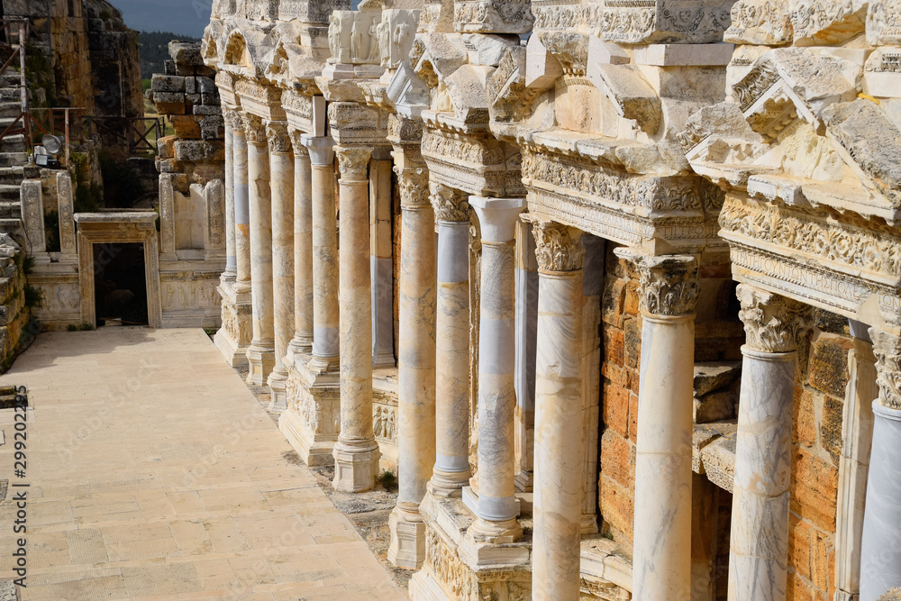 Naklejka premium Columns on the stage of the amphitheater. Ancient antique amphitheater in city of Hierapolis in Turkey.