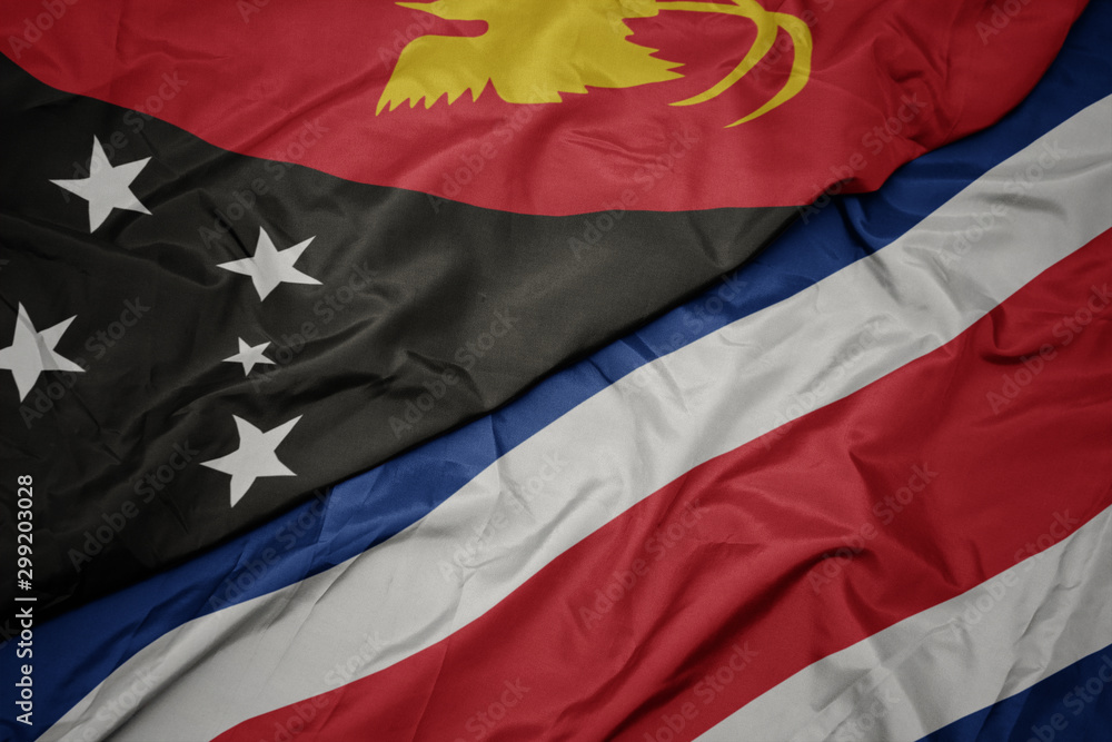 waving colorful flag of costa rica and national flag of Papua New Guinea . waving colorful flag of costa rica and national flag of Papua New Guinea .