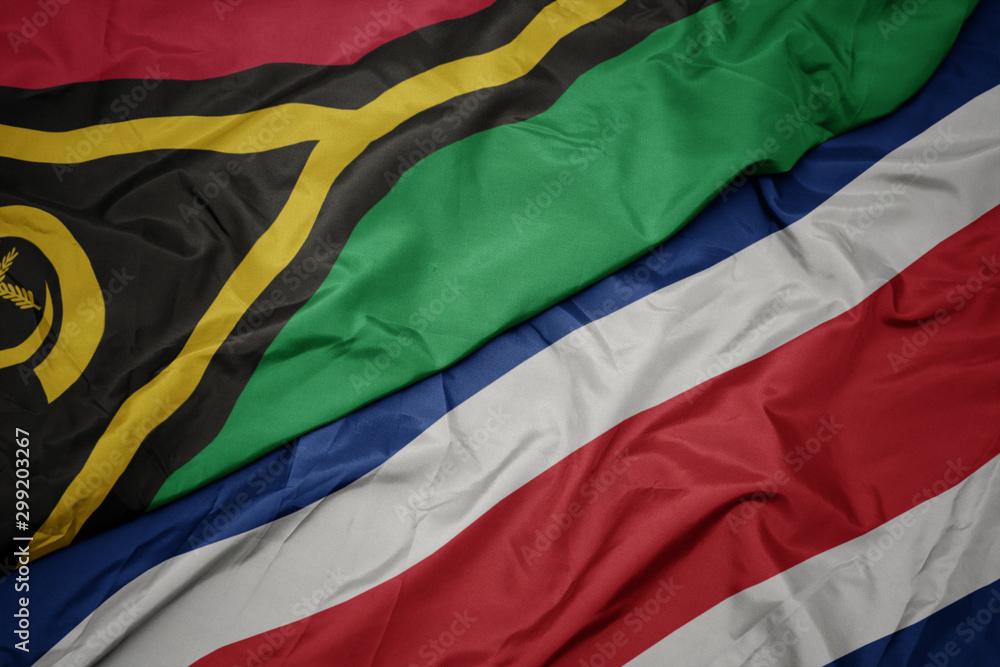 waving colorful flag of costa rica and national flag of Vanuatu .
