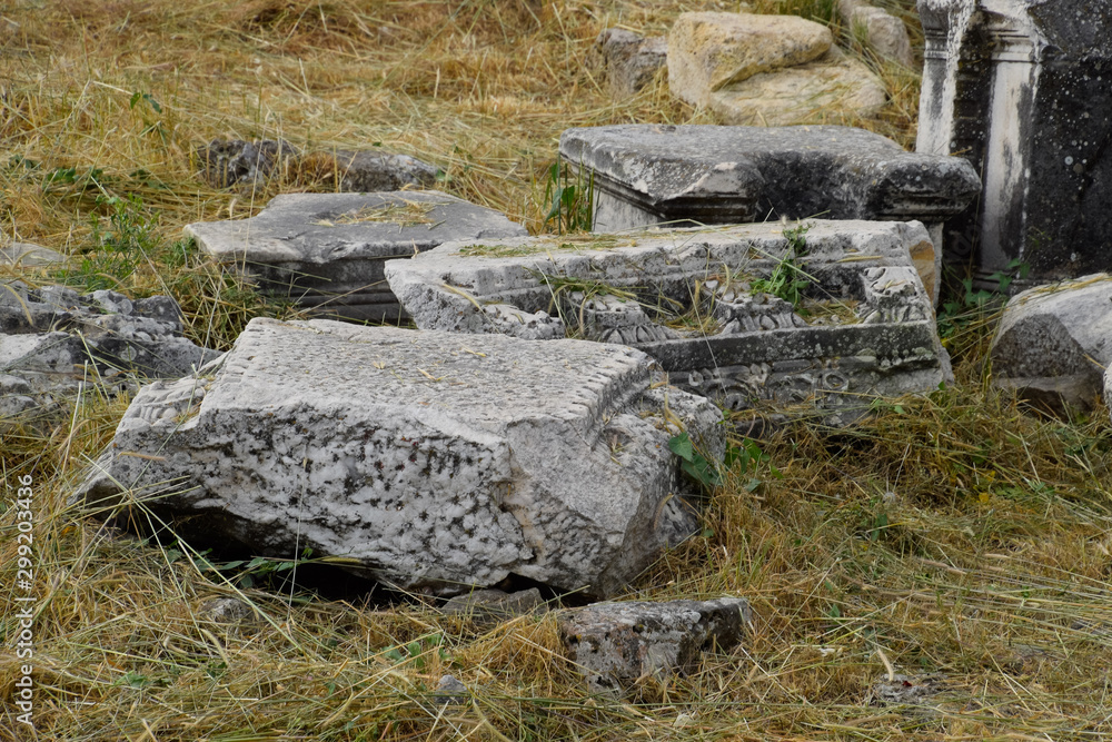 Fragments of ancient buildings, ruins of the ancient city of Hierapolis. Stone blocks with traces of stone machining. Fragments of ancient buildings, ruins of the ancient city of Hierapolis. Stone blocks with traces of stone machining.