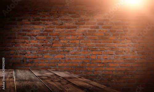 Wooden table  brick wall  ray of light. Empty scene of a dark room with old brick walls  neon light.