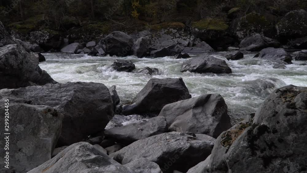 Scenic waterfall Uchar cascade view with currents and boulders. Altai mountains, Siberia, Russia. Scenic waterfall Uchar cascade view with currents and boulders. Altai mountains, Siberia, Russia.