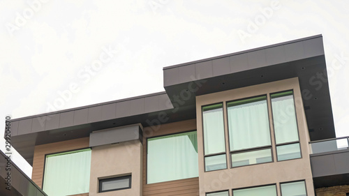 Wallpaper Mural Panorama frame Exterior of a modern home with flat rooftop large windows and stone wall Torontodigital.ca