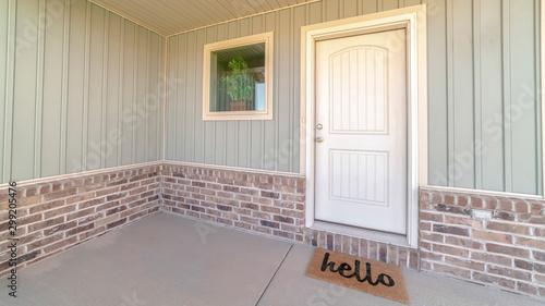 Panorama frame Front door and veranda of home with welcome mat