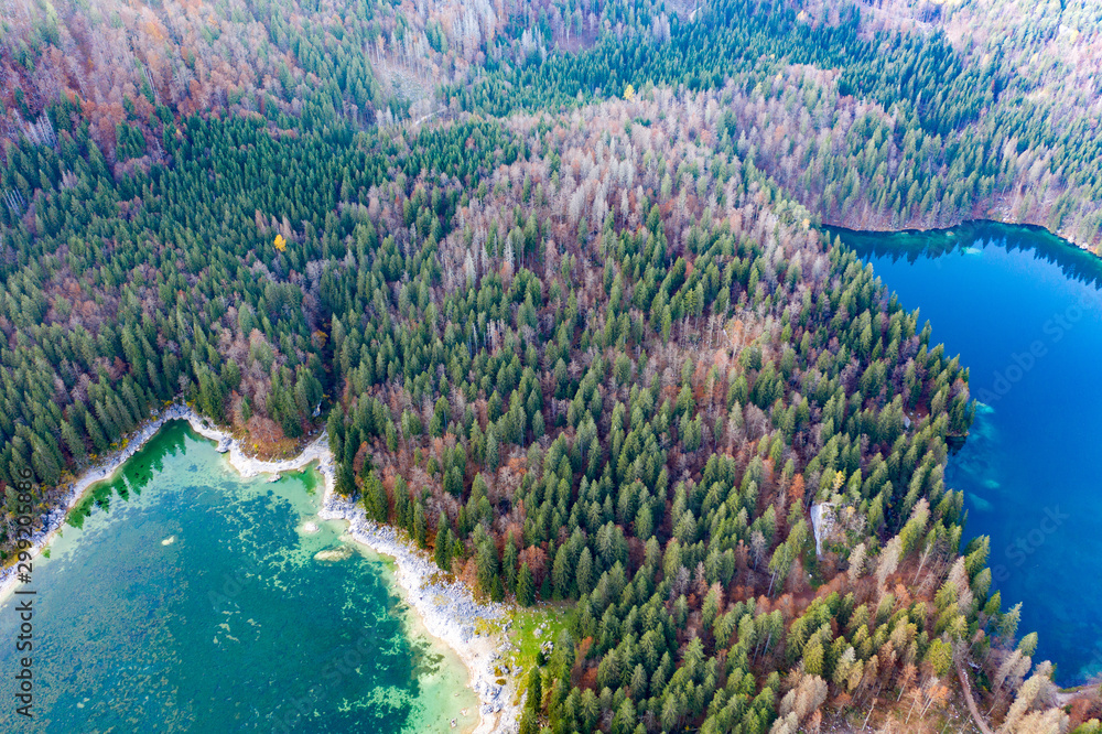 view from the drone of the autumn forest on a mountainside on the lake
