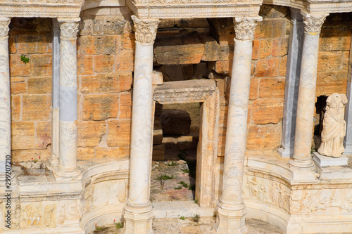 Marble statues at the columns of the amphitheater in Hierapolis, Turkey.