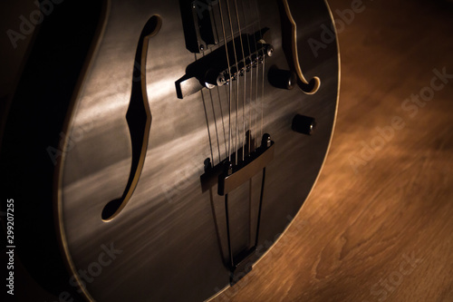 Photography Black jazz archtop guitar with holes