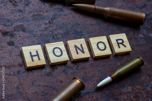 The word honor with bullets on rusty metal background. photo