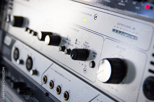 A rack of audio compressors in a recording studio.