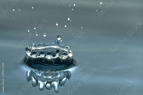 Beautiful splash of water drop on water surface  macro photo