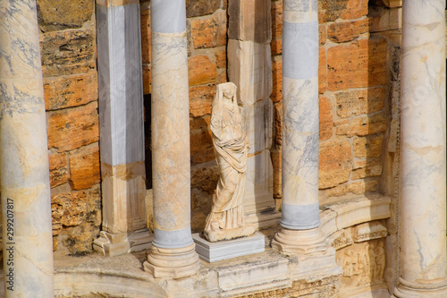 Marble statues at the columns of the amphitheater in Hierapolis, Turkey.