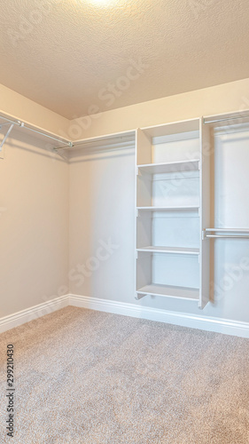Vertical Interior of walk in closet with bare shelving