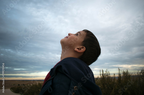 Child looking up the sky