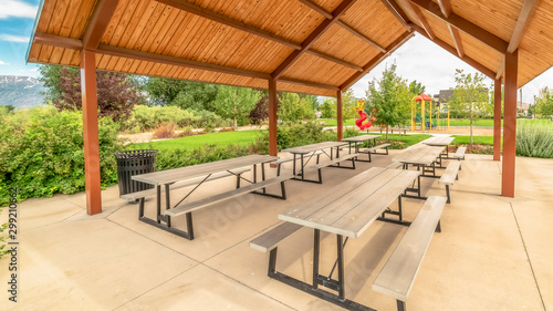 Photos Panorama frame Pavilion at a park with view of playground lush foliage and dista