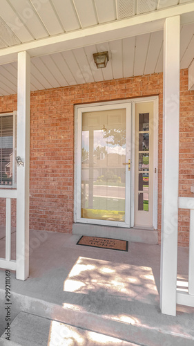 Vertical Front porch and door of traditional brick home