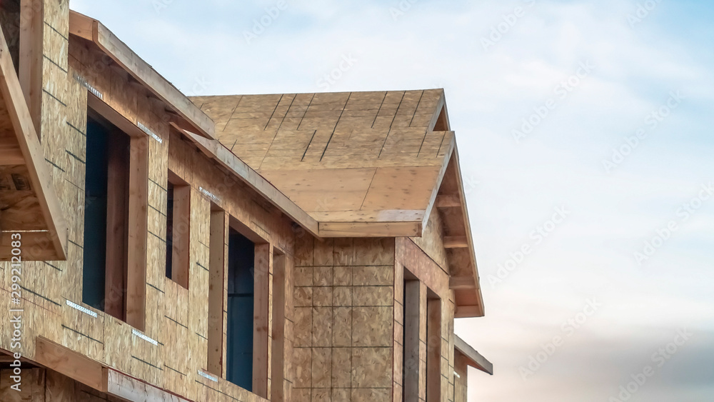 Panorama Close up of the exterior of townhomes under construction against cloudy sky