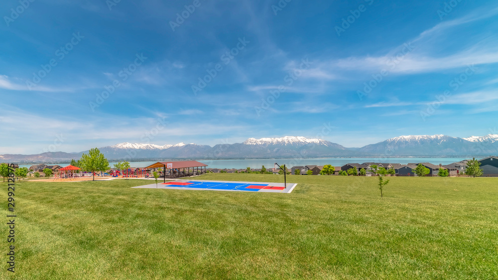 Panorama Scenic lake landscape with basketball court picnic pavilion and family homes Panorama Scenic lake landscape with basketball court picnic pavilion and family homes