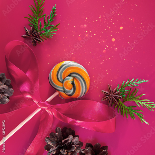 Christmas candy on a pink background, like a magic wand. Christmas composition with place for text.