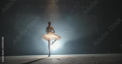 Beautiful artist performing, dancing ballet on spotted stage, choreographer setting a performance, isolated on black background - arts concept 4k footage