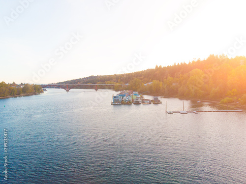 A pier with houses on the water in the USA at sunset in autumn, shot from above using a drone