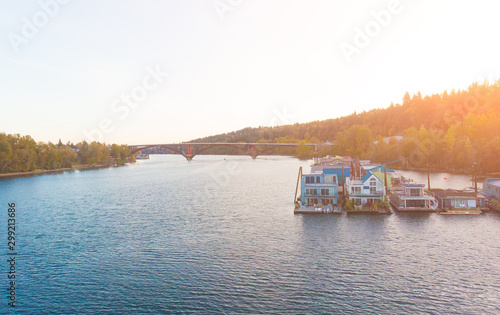 A pier with houses on the water in the USA at sunset in autumn, shot from above using a drone