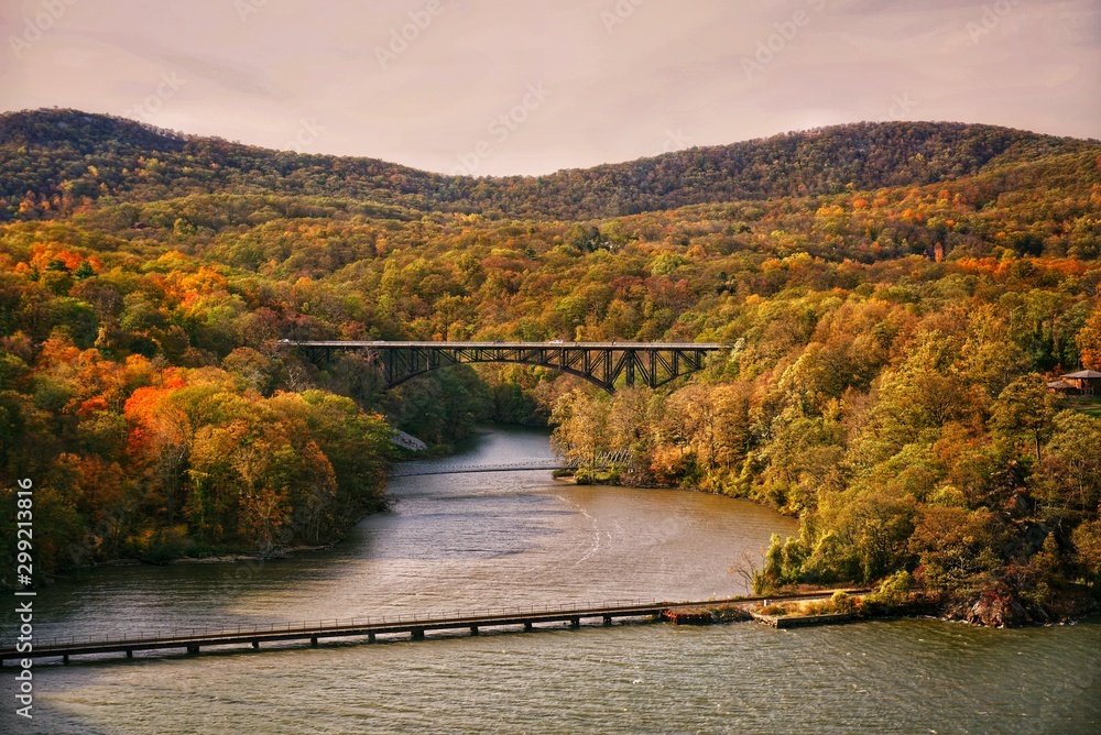 Landscape view of a bridge and mountains in early fall during the sunset at Bear Mountain State Park