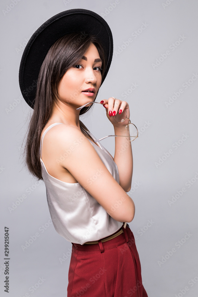 Young pretty asian woman holding coffee and take selfie over white background Young pretty asian woman holding coffee and take selfie over white background