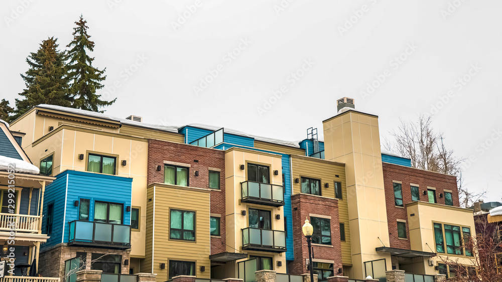 Panorama Townhomes facade with balconies in Park City Utah against cloudy sky in winter