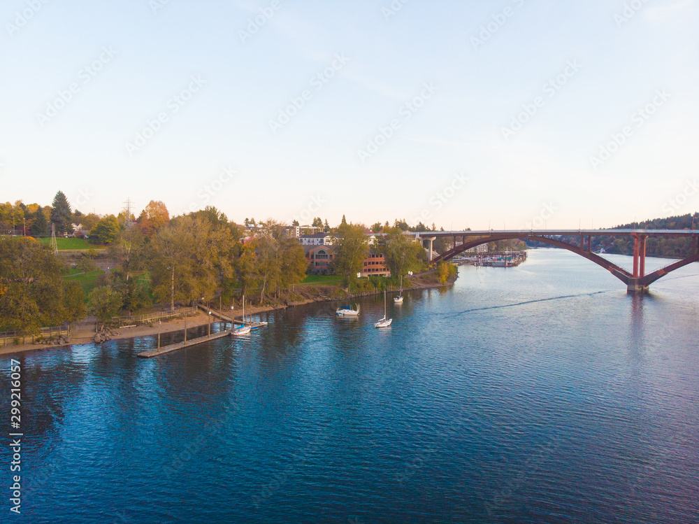 Obraz premium Autumn sunset with a bridge over the river, landscape shot from a height