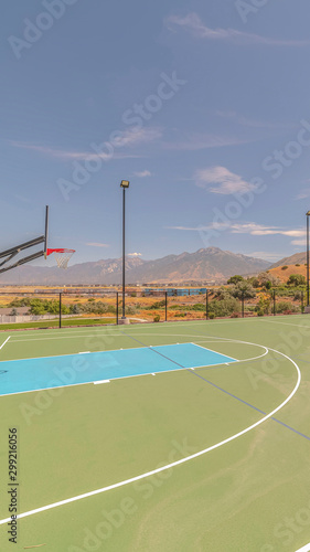 Vertical Outdoor turf basketball court on sunny, clear day