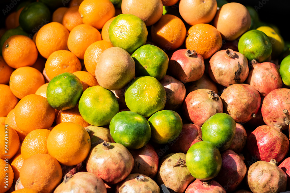 tangerines pomegranate and orange heap close-up. On the light of day. tangerines pomegranate and orange heap close-up. On the light of day.