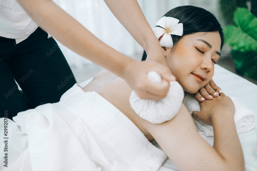 Beautiful young woman lying down on beds massage and spa at asian spa massage and beauty salon center, spa concept, massage concept Beautiful young woman lying down on beds massage and spa at asian spa massage and beauty salon center, spa concept, massage concept