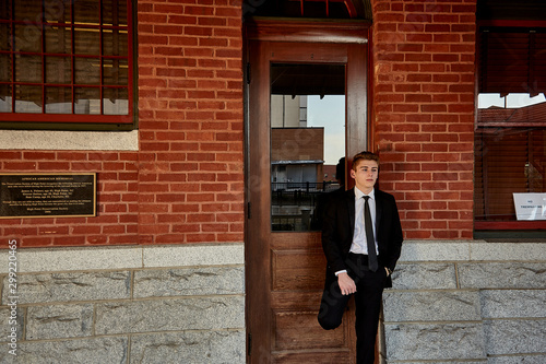 businessman standing in front of office building