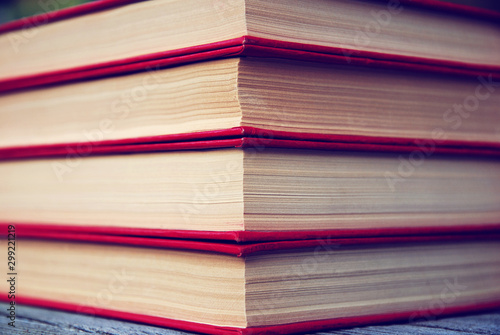 Law books background  book edge closeup  stack of books in red covers  legislation  multivolume edition  full frame texture