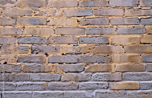 Old decaying brick and mortar wall, aged and weathered empty surface.