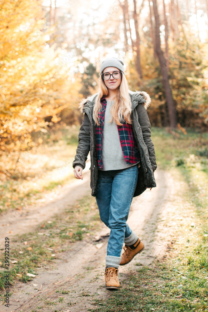 Hiking and travel along in the forest. Concept of trekking, adventure and seasonal vacation. Young woman walking in woods. Hiking and travel along in the forest. Concept of trekking, adventure and seasonal vacation. Young woman walking in woods.